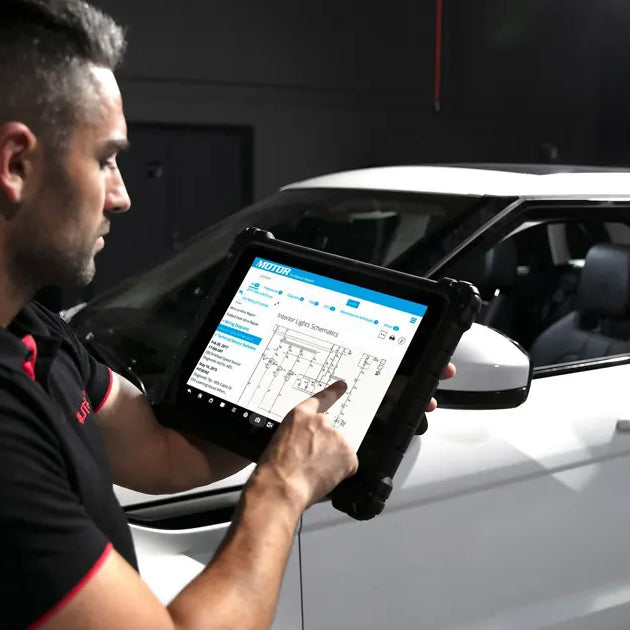 Car diagnostic equipment is being used for repair work.