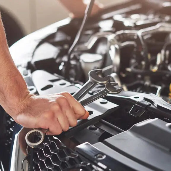 Mechanic is repairing and diagnosing car engine.